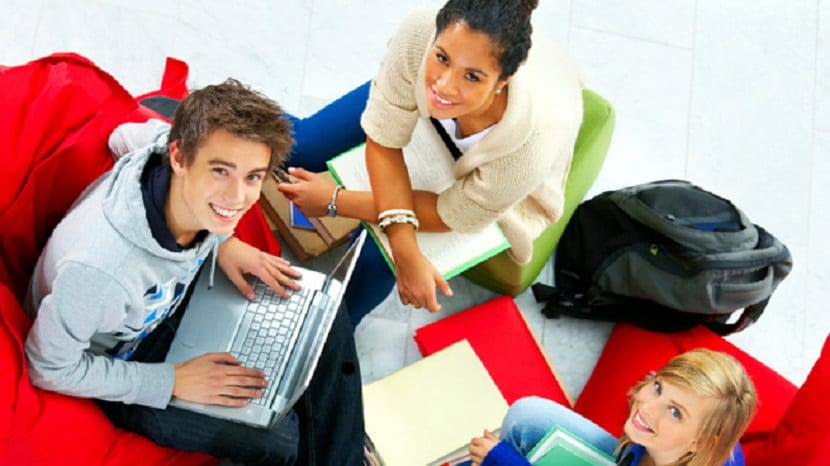 Studygroup relaxing in beanbags while doing school work.